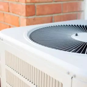 A detailed close-up of an outdoor air conditioning unit shows the fan grill, metal fins, and clean condenser surface, highlighting the quality and condition of the cooling system. The image emphasizes the importance of regular HVAC maintenance, proper installation, and energy-efficient equipment for reliable summer comfort. Ideal for promoting air conditioning tune-ups, system inspections, and professional HVAC services for residential and commercial customers.