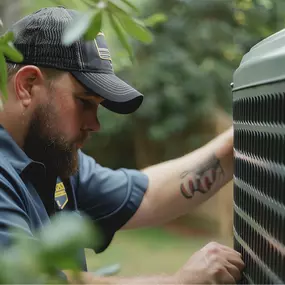 An HVAC technician is actively working on an outdoor air conditioning unit, inspecting components, checking refrigerant levels, and ensuring the system is running efficiently. Wearing a professional uniform and using diagnostic tools, the technician performs routine maintenance or repairs to restore reliable cooling. This image highlights expert A/C service, energy-efficient performance, and the importance of seasonal HVAC maintenance for residential or commercial systems.