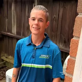 Techmazing Heating and Cooling technician Van standing by an HVAC unit, ensuring reliable comfort and top-quality service for every customer