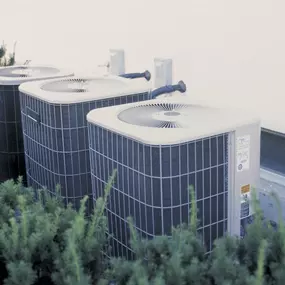 A row of outdoor air conditioning units sits beside a residential or commercial building, showcasing modern HVAC equipment used for cooling homes and businesses. The units are clean, professionally installed, and ready to keep indoor spaces comfortable during hot weather. This image represents reliable air conditioning systems, energy-efficient cooling, and the importance of proper A/C installation and maintenance by certified HVAC technicians.