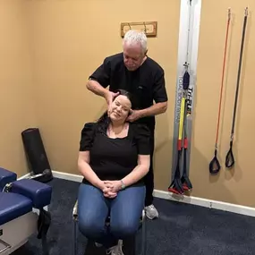 Dr. R. Todd Kirstein adjusting a patient's neck
