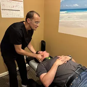 Dr. Gage Kirstein adjusting a patient's neck