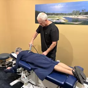 Dr. R. Todd Kirstein performing shockwave therapy on a patient's neck