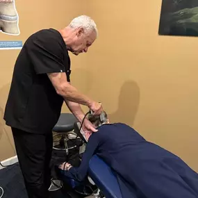 Dr. R. Todd Kirstein performing shockwave therapy on a patient's neck