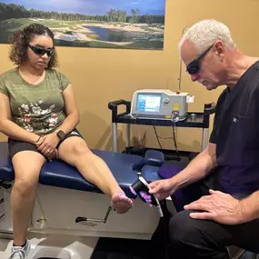 Dr. R. Todd Kirstein performing shockwave therapy on a patient's foot