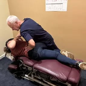 Dr. R. Todd Kirstein adjusting a patient's back