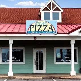 Exterior view of Southern Shores Pizza restaurant with front entrance and signage.