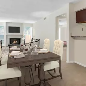 A dining room with a table set for four.
