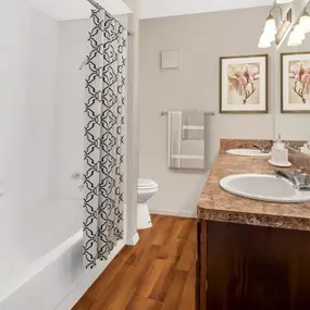 A bathroom with two white sinks and a mirror