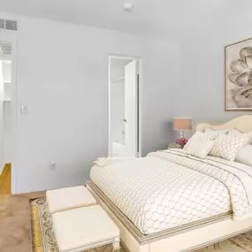 A bedroom with a large bed and a window