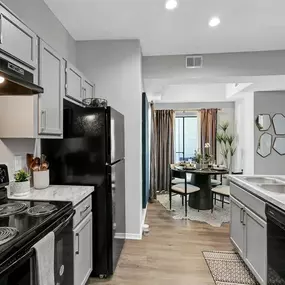 An empty kitchen with a stove and a refrigerator