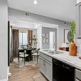 An open kitchen and dining room with a table and chairs