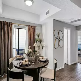 An open living room and dining room with a table and chairs