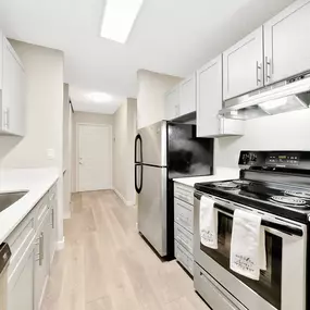 A modern kitchen with a black stove top oven.