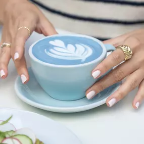 Ginger Tea Latte made with blue pea tea and steamed milk - avibrant wellness drink.