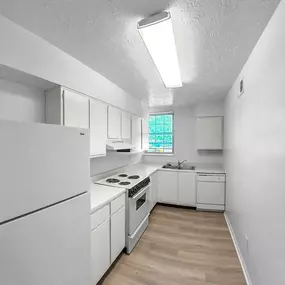 a white kitchen with white appliances and white cabinets