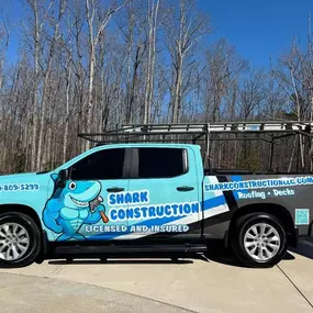 This image showcases a light blue pickup truck with a 