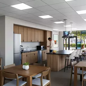The interior view of a community room with big windows and wooden furniture