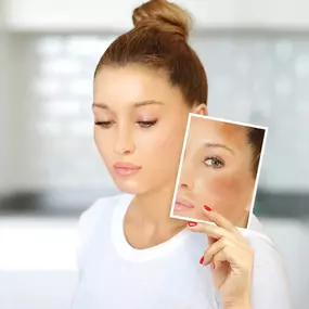 A professional headshot of a woman with her eyes closed and head tilted, gently touching her jawline. Her skin appears smooth and well-hydrated, conveying a sense of serenity and care.