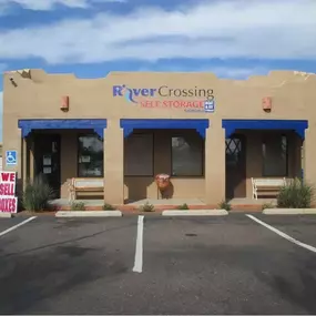 Secure exterior of River Crossing Storage & RV facility in Goodyear, AZ, featuring ample parking and easy-to-navigate driveways for smooth loading and unloading.