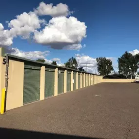 Well-maintained outdoor storage units with wide aisles for easy access at River Crossing Storage & RV in Goodyear, AZ, perfect for household items and business storage.