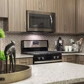a kitchen with a stove top oven and a microwave