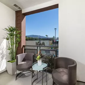 a patio with two chairs and a table