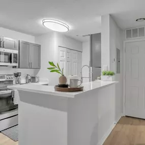 a white kitchen with a counter top and