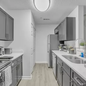 a kitchen with stainless steel appliances and white counter tops