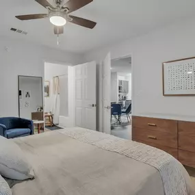 a bedroom with a bed and a ceiling fan