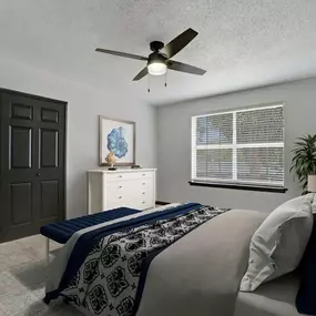 A bedroom with a bed and a ceiling fan