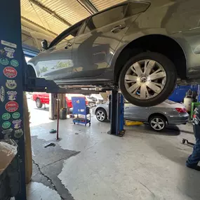 I & F Transmission Specialist - car on lift awaiting transmission service