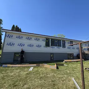This photo captures the siding installation process in progress on a home in Shakopee, Minnesota. Gehlen Construction is in the midst of replacing the old exterior with brand-new, high-quality siding materials.
