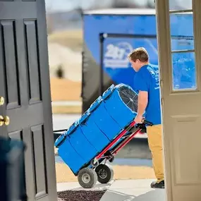 Team member from First Response Restoration of RGV transporting industrial air movers on a cart into a home in the Rio Grande Valley. Wearing a branded blue uniform, this image showcases our 24/7 emergency water damage and flood restoration services in McAllen, Brownsville, and surrounding areas. IICRC certified (#70221362). Call (956) 305-4229 for immediate assistance.
