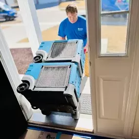 Team member from First Response Restoration of RGV delivering dehumidifiers into a home in the Rio Grande Valley. Wearing a branded blue uniform, this image showcases our 24/7 water damage and flood restoration services in McAllen, Brownsville, and surrounding areas. IICRC certified (#70221362). Call (956) 305-4229 for immediate service.