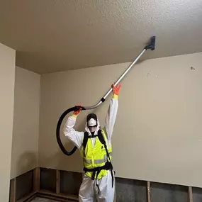 Team member from First Response Restoration of RGV using a HEPA vacuum for mold remediation in the Rio Grande Valley. Wearing a protective suit and vest, this image highlights our 24/7 biohazard cleanup and restoration services in McAllen, Brownsville, and beyond. IICRC certified (#70221362). Call (956) 305-4229 for immediate help.