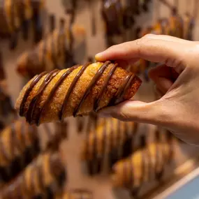 A hand holding a nutella pastry.