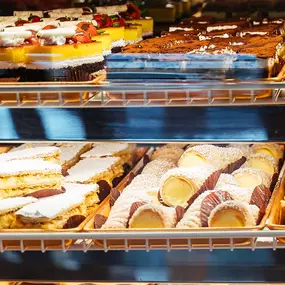 An assortment of desserts in a display case.
