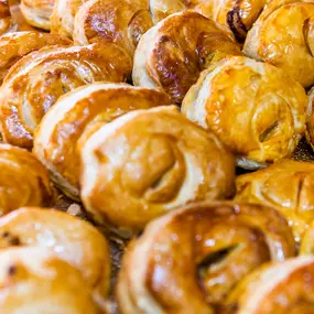 Several meat pastries in a case.