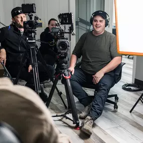 Our team is smiling and working on a video production shoot.