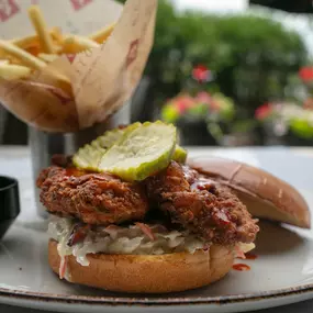 Buttermilk Fried Chicken | crispy chicken, pickles, sweet coleslaw, brioche bun. Available in Nashville Hot, Buffalo, or Hot Honey.