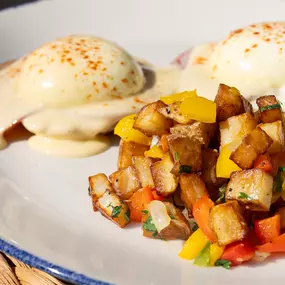 Eggs Benedict | english muffin, poached egg, wood grilled canadian bacon, hollandaise & hash browns