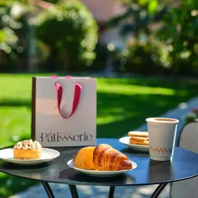 Stop by for an artisanal coffee and pick up a pastry to enjoy in our courtyard surrounded by lush gardens.