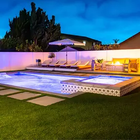 Custom swimming pool with lighting for night use.