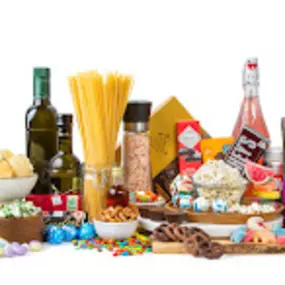 A vibrant assortment of premium bulk candy, bulk chocolate, and gourmet food items, including pasta, olive oil, popcorn, and artisanal treats.