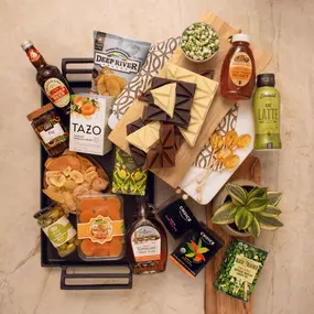 Gourmet wholesale selection with artisan chocolate, dried fruit, maple syrup, honey, tea, and snacks.