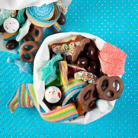 Yummy gummy candies, gummi sharks, ropes, and chocolate pretzels for National Candy Day.