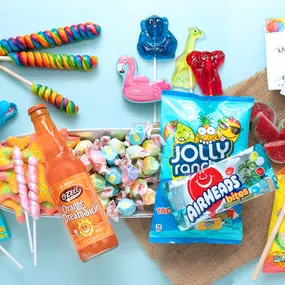 Group shot of fun novelty and sour candies with Jolly Ranchers, Airheads, Sour Patch Kids, lollipops, and Jones sodas