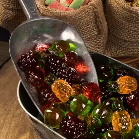 Bulk gummy candy shaped like fruit, ready for scooping into custom displays or packaging.