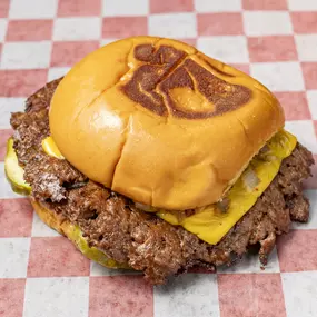 Double patty, 100% fresh beef burger served with American cheese, grilled onions, pickles and house sauce on a Martin's potato bun